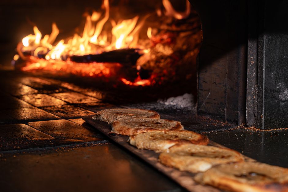 Freshly baked bread in a traditional wood-fired oven, showcasing rustic baking methods.