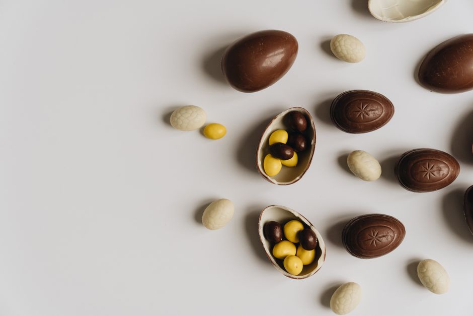 A creative flat lay of assorted chocolate eggs perfect for Easter celebrations and candy lovers.
