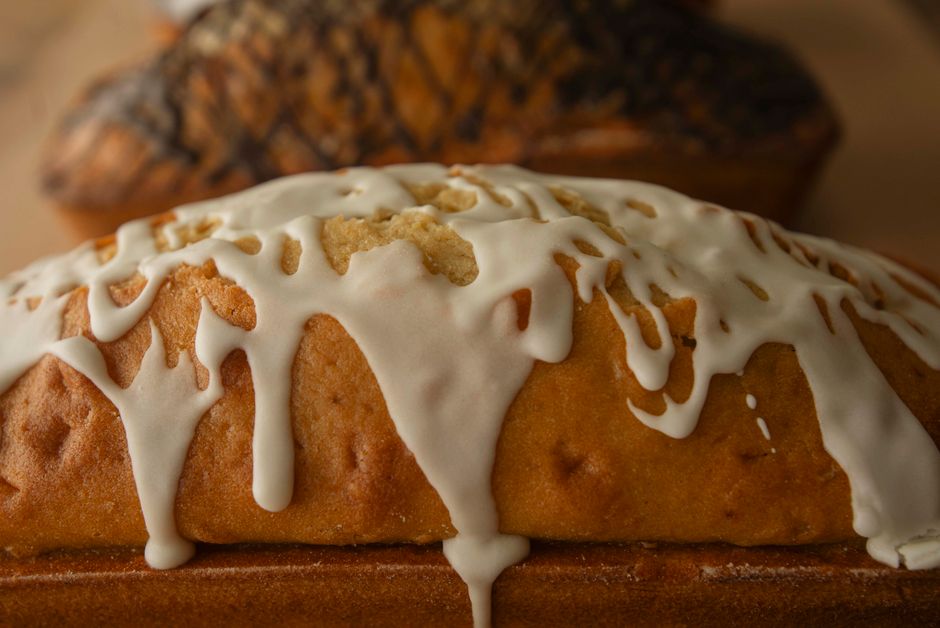 Delicious vanilla pound cake with a creamy white glaze drizzled on top.