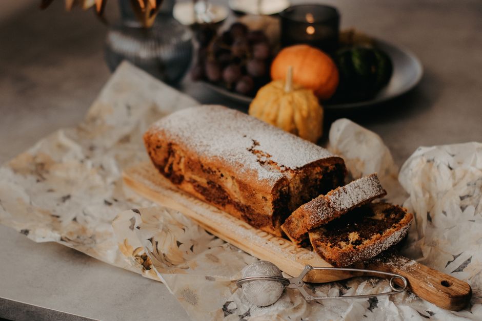 Loaf cake with orange slices on baking paper