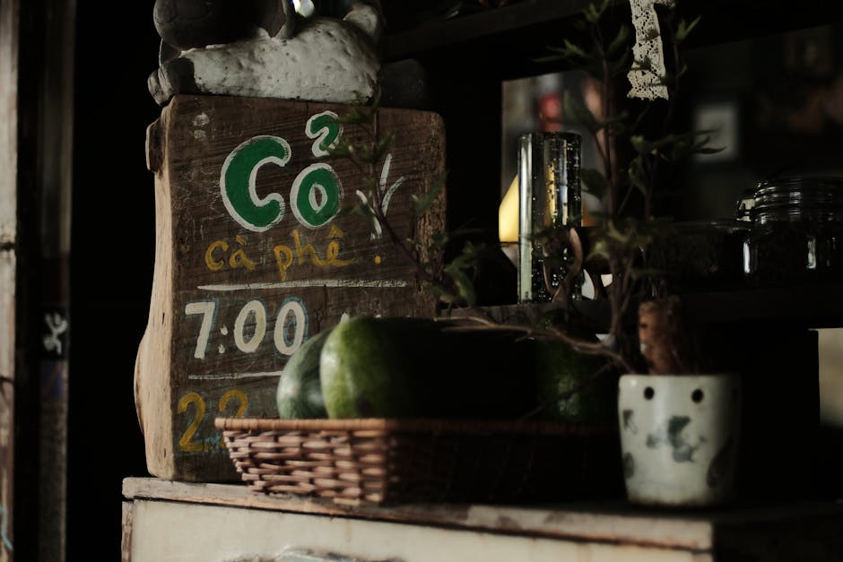 Cozy indoor café setting featuring a rustic wooden sign with artistic decor and subdued lighting.