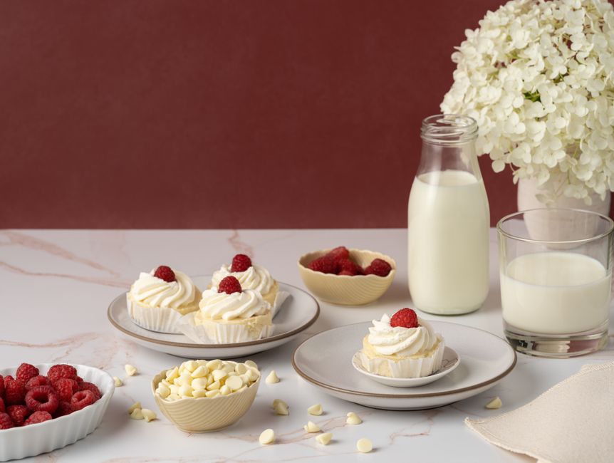 Elegant display of raspberry cupcakes and milk, perfect for dessert lovers.