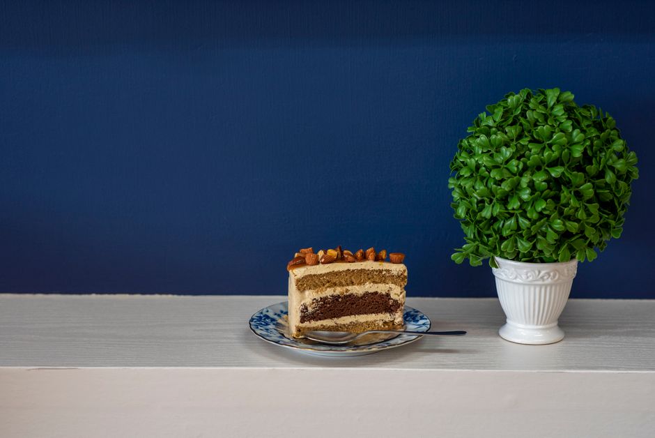 Slice of layered sponge cake on a cake stand