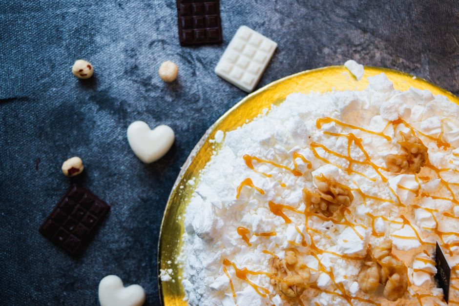 Delicious dessert with whipped toppings and chocolate pieces on a rustic background.