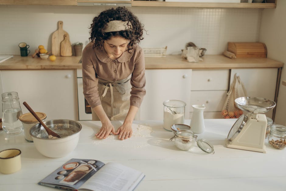 A woman preparing dough in a cozy kitchen setting with various baking tools.